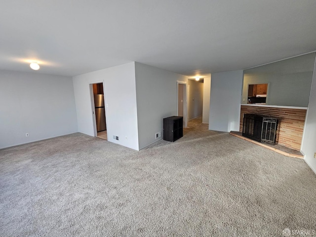 unfurnished living room featuring carpet floors