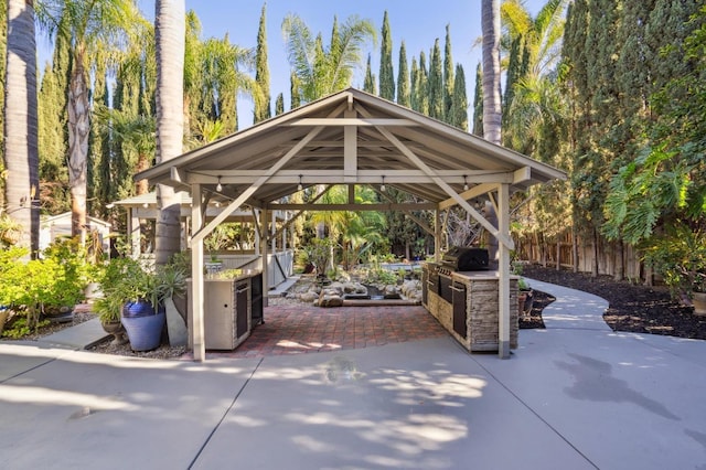 view of home's community featuring a gazebo, an outdoor kitchen, and a patio