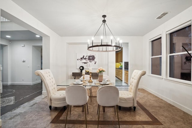 dining space with an inviting chandelier