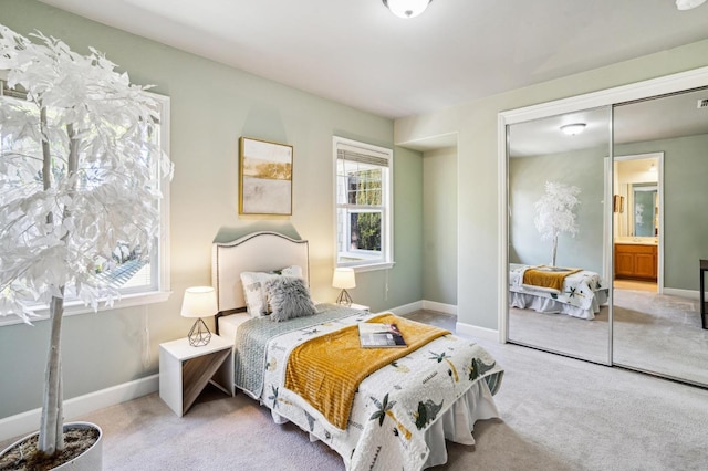 carpeted bedroom featuring multiple windows and a closet