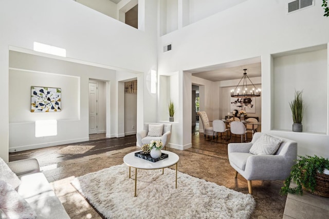 living room featuring a notable chandelier and a towering ceiling