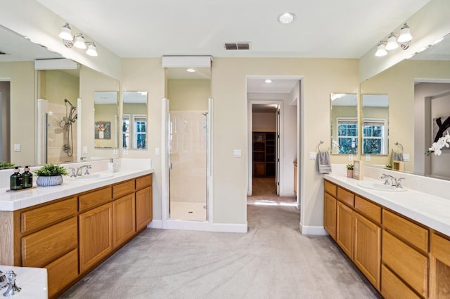 bathroom with walk in shower and vanity