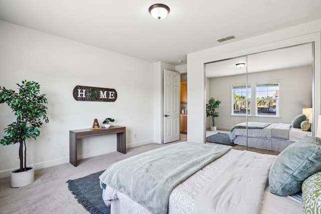 bedroom featuring a closet and light carpet