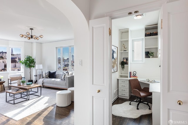 office area featuring dark hardwood / wood-style flooring, built in desk, and a wealth of natural light