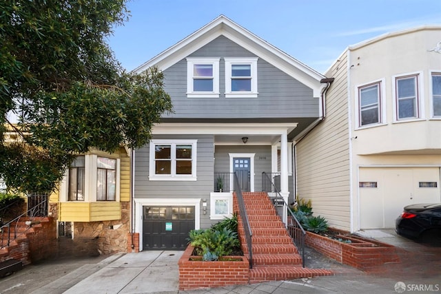 view of front of property with a porch, concrete driveway, a garage, and stairs