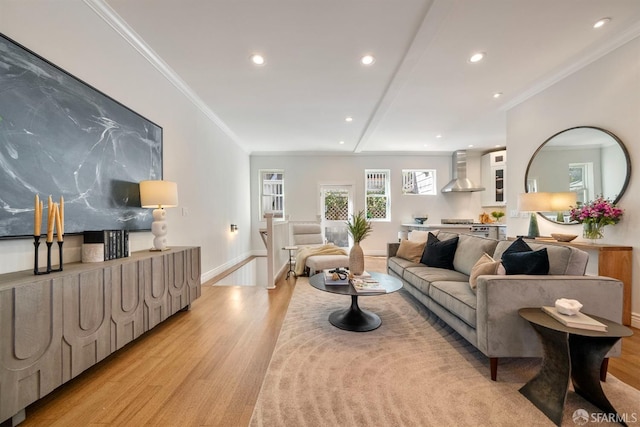 living area featuring ornamental molding, light wood-type flooring, baseboards, and recessed lighting