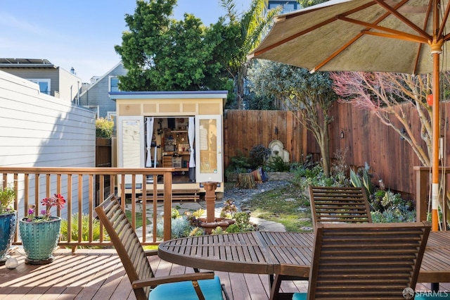 wooden terrace featuring a storage shed