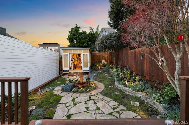 yard at dusk with an outbuilding