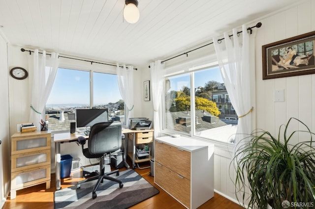 office area featuring plenty of natural light, dark wood-type flooring, and wooden ceiling