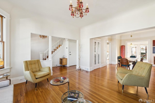 living room featuring wood-type flooring and a chandelier