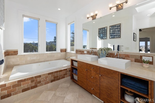 bathroom featuring vanity and tiled tub