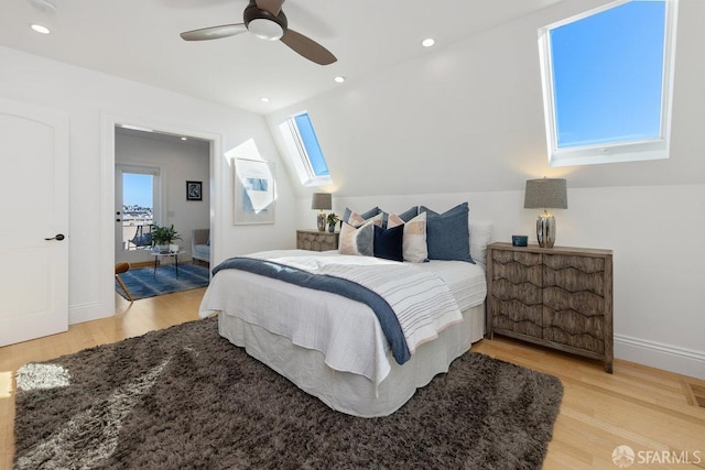 bedroom featuring a skylight, ceiling fan, and light wood-type flooring