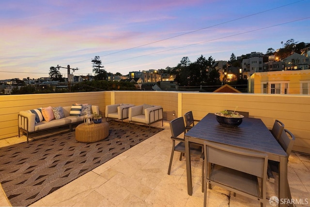 patio terrace at dusk featuring an outdoor living space