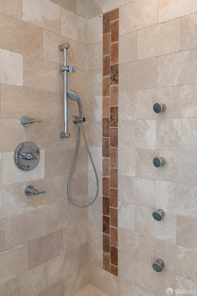 bathroom with a tile shower