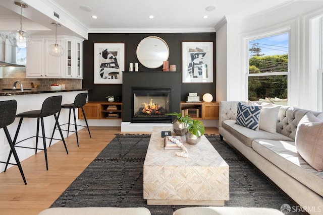 living room featuring crown molding and hardwood / wood-style flooring