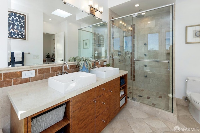 bathroom with walk in shower, vanity, and toilet