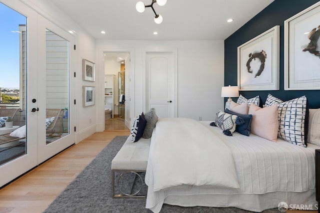 bedroom with french doors and light hardwood / wood-style flooring