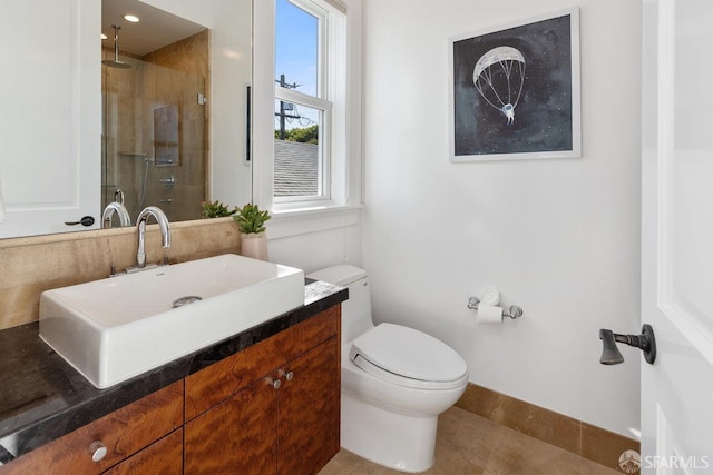 bathroom with vanity, toilet, and walk in shower