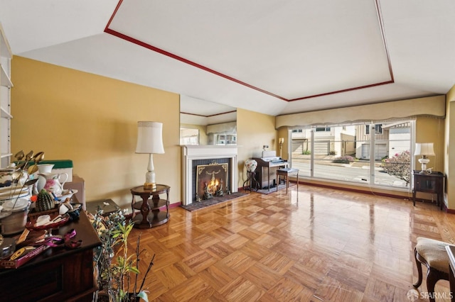 living room featuring a tile fireplace, a raised ceiling, and lofted ceiling