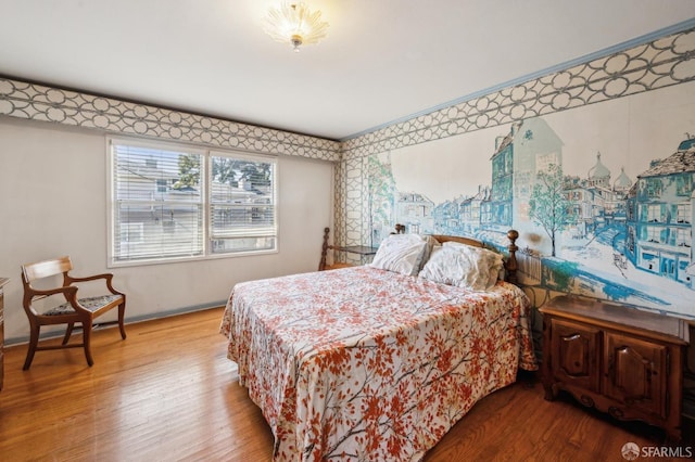 bedroom featuring baseboards and wood finished floors