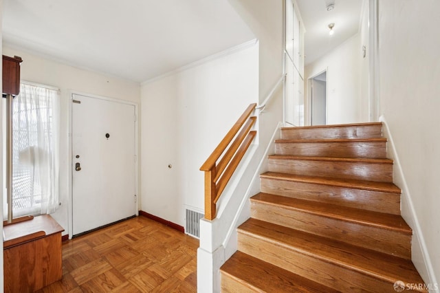 entryway featuring baseboards, stairs, and visible vents