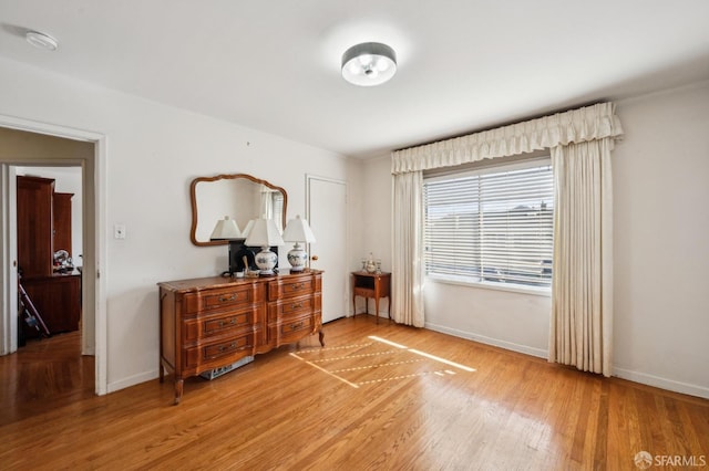 interior space featuring light wood-type flooring and baseboards