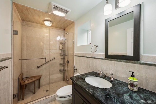 full bath featuring toilet, vanity, a shower stall, and visible vents