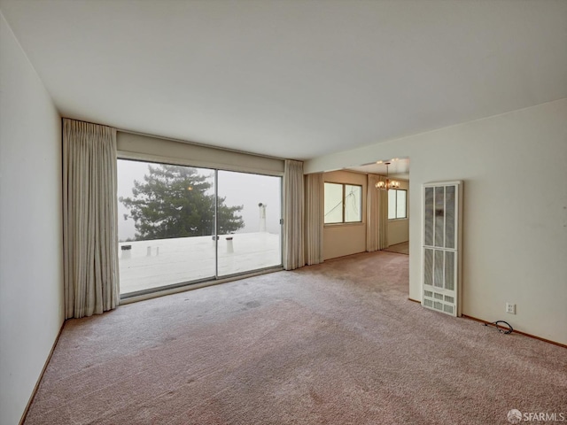 empty room with a chandelier and carpet