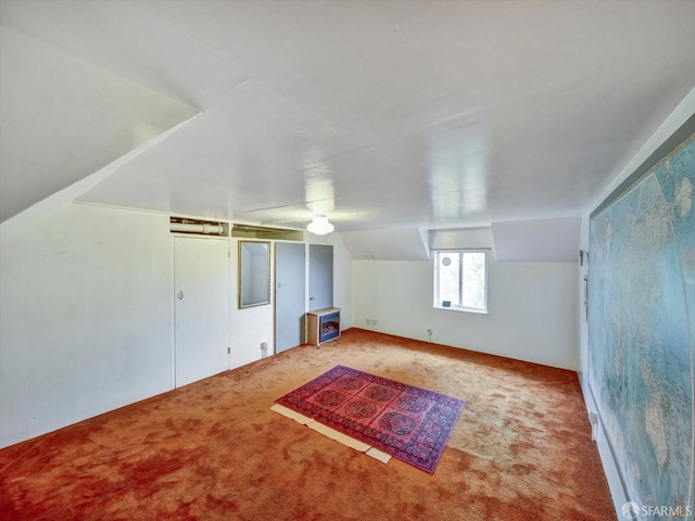 additional living space featuring vaulted ceiling and carpet floors