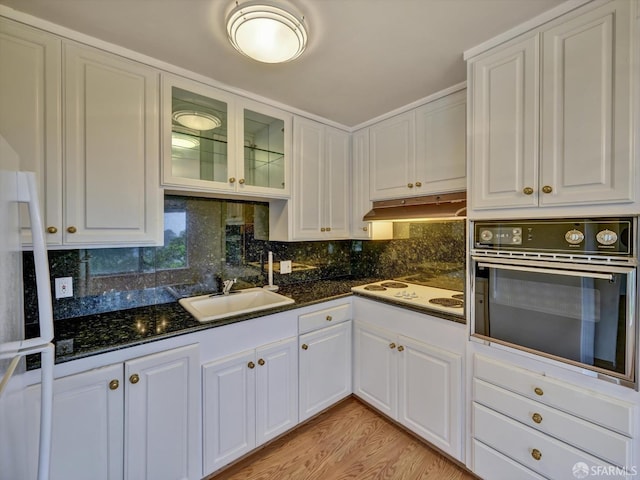 kitchen with white cabinets, oven, sink, and white electric stovetop