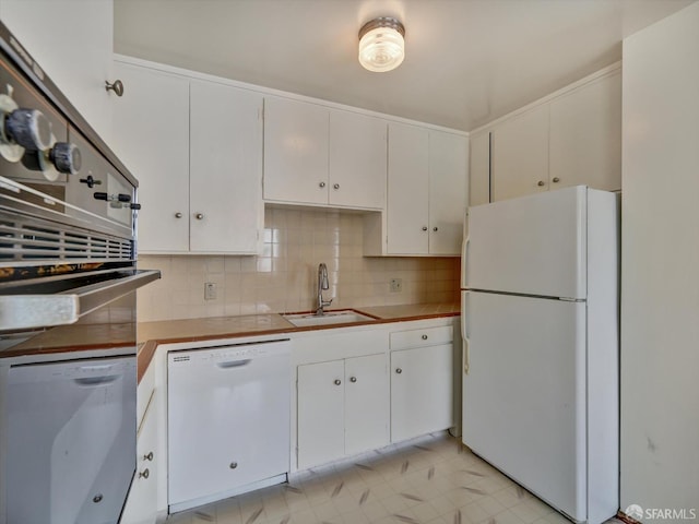 kitchen featuring tasteful backsplash, sink, white cabinets, and white appliances