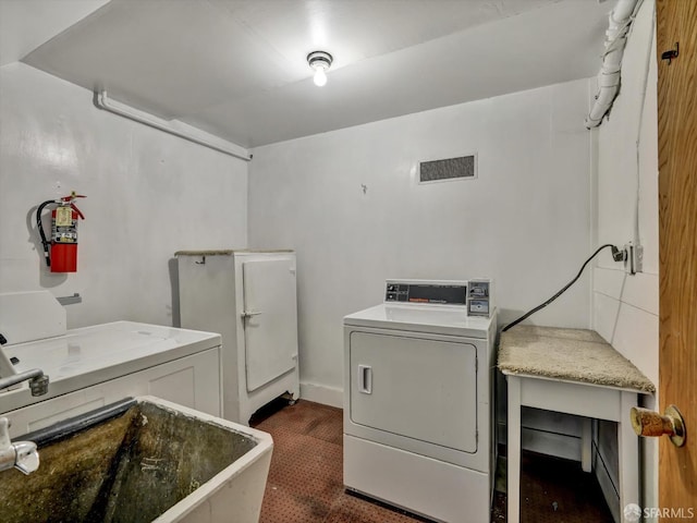 washroom featuring sink and washer and dryer