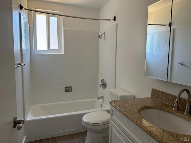 full bathroom featuring toilet, vanity, hardwood / wood-style floors, and bathtub / shower combination