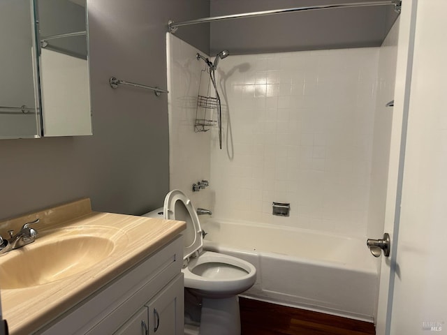 full bathroom with toilet, wood-type flooring, vanity, and tiled shower / bath combo