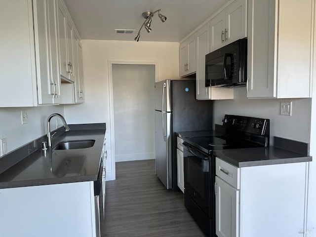 kitchen with black appliances, dark hardwood / wood-style flooring, white cabinets, and sink