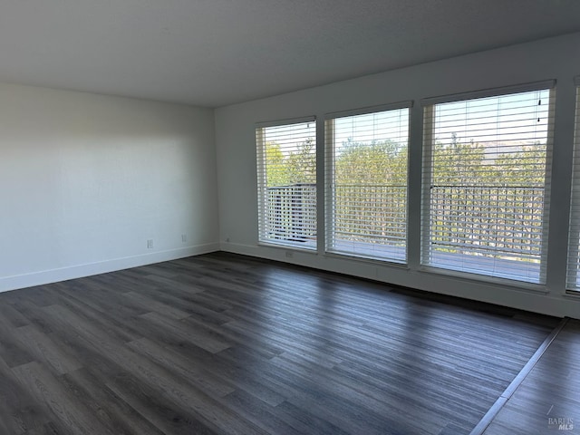 spare room featuring dark hardwood / wood-style flooring