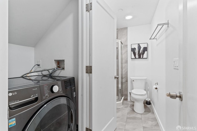 washroom with laundry area, washer / dryer, and baseboards