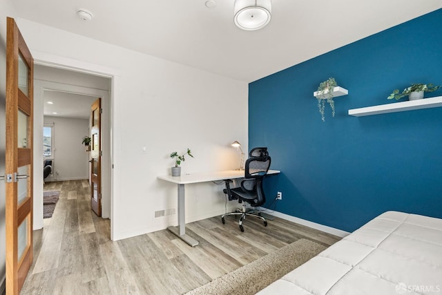 office space with visible vents, baseboards, and wood finished floors