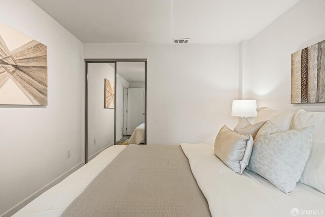 bedroom with a closet and visible vents