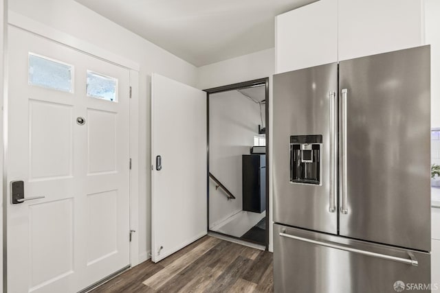 kitchen with dark wood-style floors, high quality fridge, and white cabinets