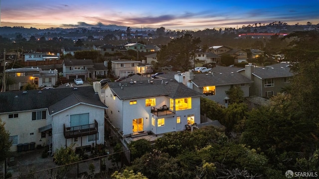 aerial view at dusk featuring a residential view