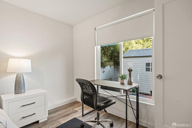 office area with light wood-style flooring and baseboards