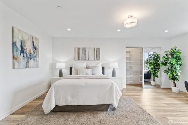 bedroom with recessed lighting, access to outside, baseboards, and light wood finished floors