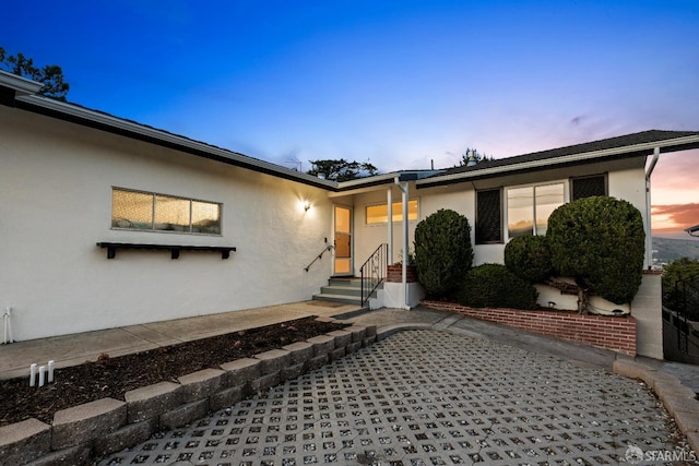 property entrance featuring stucco siding