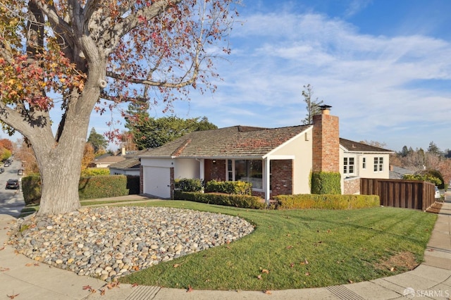 ranch-style home featuring a front yard and a garage