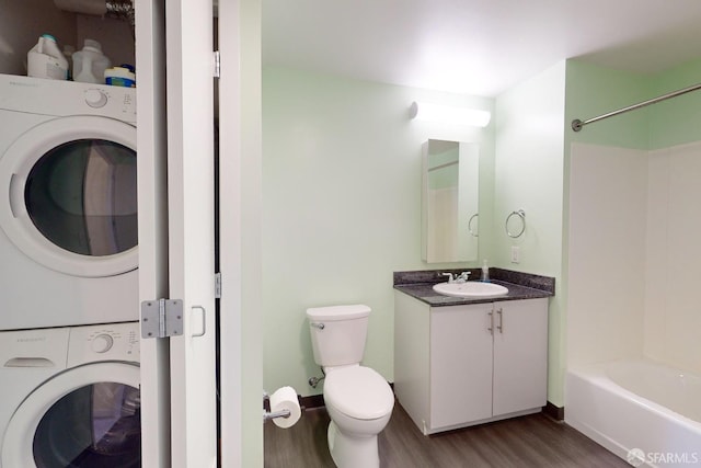 full bathroom with shower / tub combination, stacked washer / drying machine, toilet, and wood-type flooring