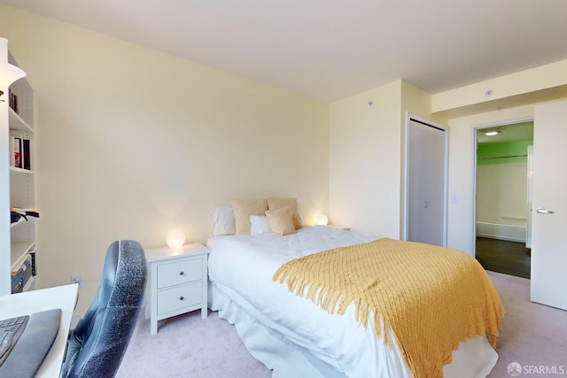 bedroom with light carpet and a closet