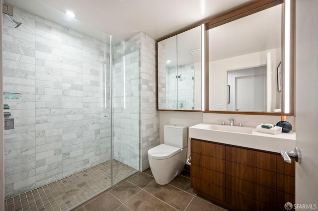 bathroom featuring toilet, vanity, an enclosed shower, and tile patterned flooring