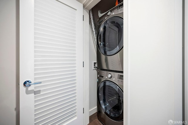 washroom featuring stacked washing maching and dryer