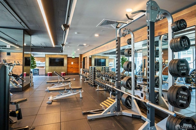 exercise room featuring wood walls